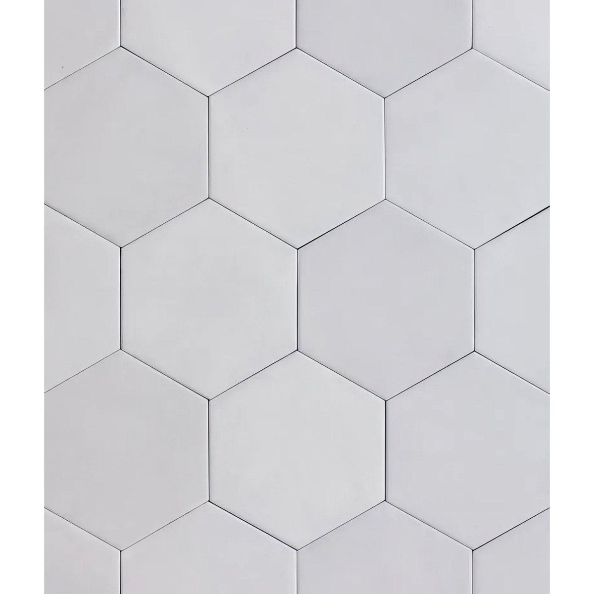 Medina hexagon porcelain latte white hexagonal tiles with smooth matte finish arranged in a geometric pattern