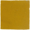 A square matte-finished mustard-yellow ceramic Medina Ochre handmade Moroccan zellige tile with slight texture and imperfections