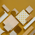 Medina ochre square handmade moroccan zellige tile with white base and repeating yellow sunburst ceramic pattern