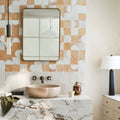 Beige ceramic bowl sink with matte finish set into white marble countertop featuring medina pure white belen zellige tile