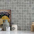 Gray medine patterned mosaic tile wall with intricate repeating patterns in varying gray and white shades