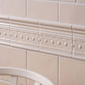 Beige ceramic melford field tile border with raised oval and dot patterns for decorative edging