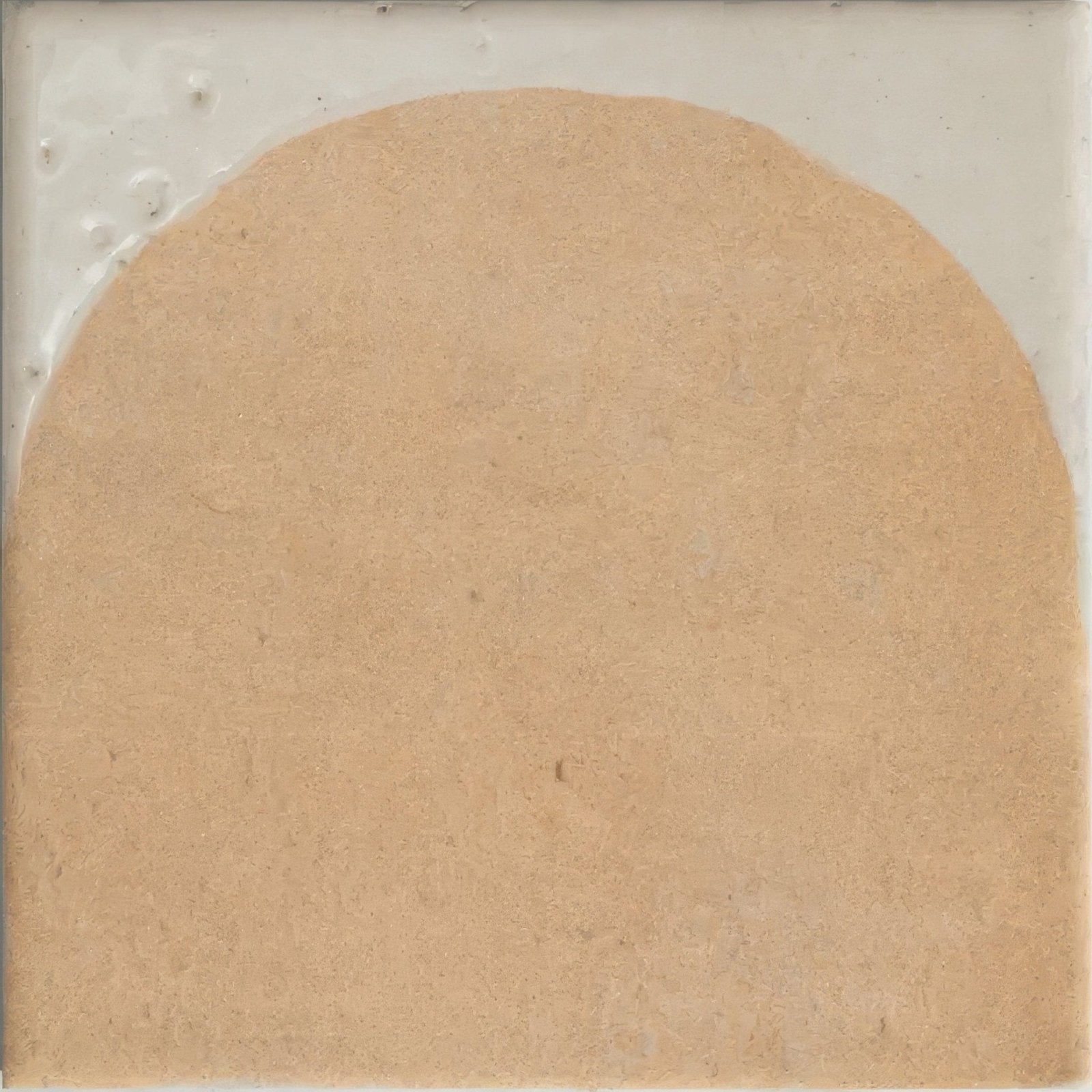 Beige textured porcelain tile with slightly raised circular center from menara cotto arches collection