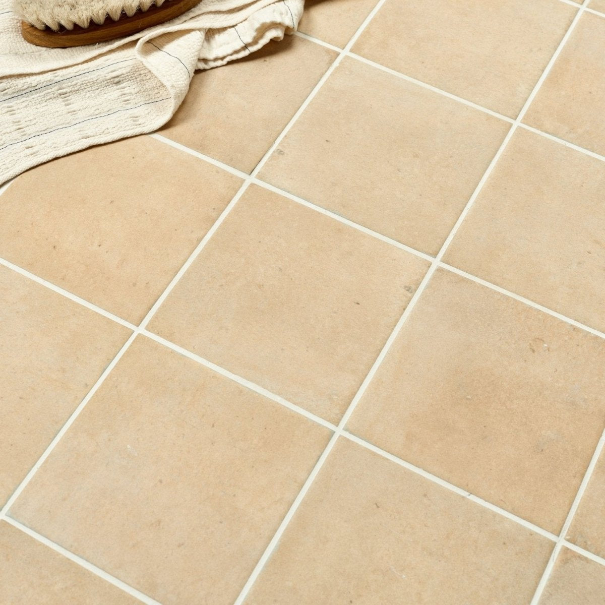 Beige menara cotto porcelain matt square tiles with white grout lines and a matte finish