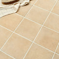 Beige menara cotto porcelain matt square tiles with white grout lines and a matte finish