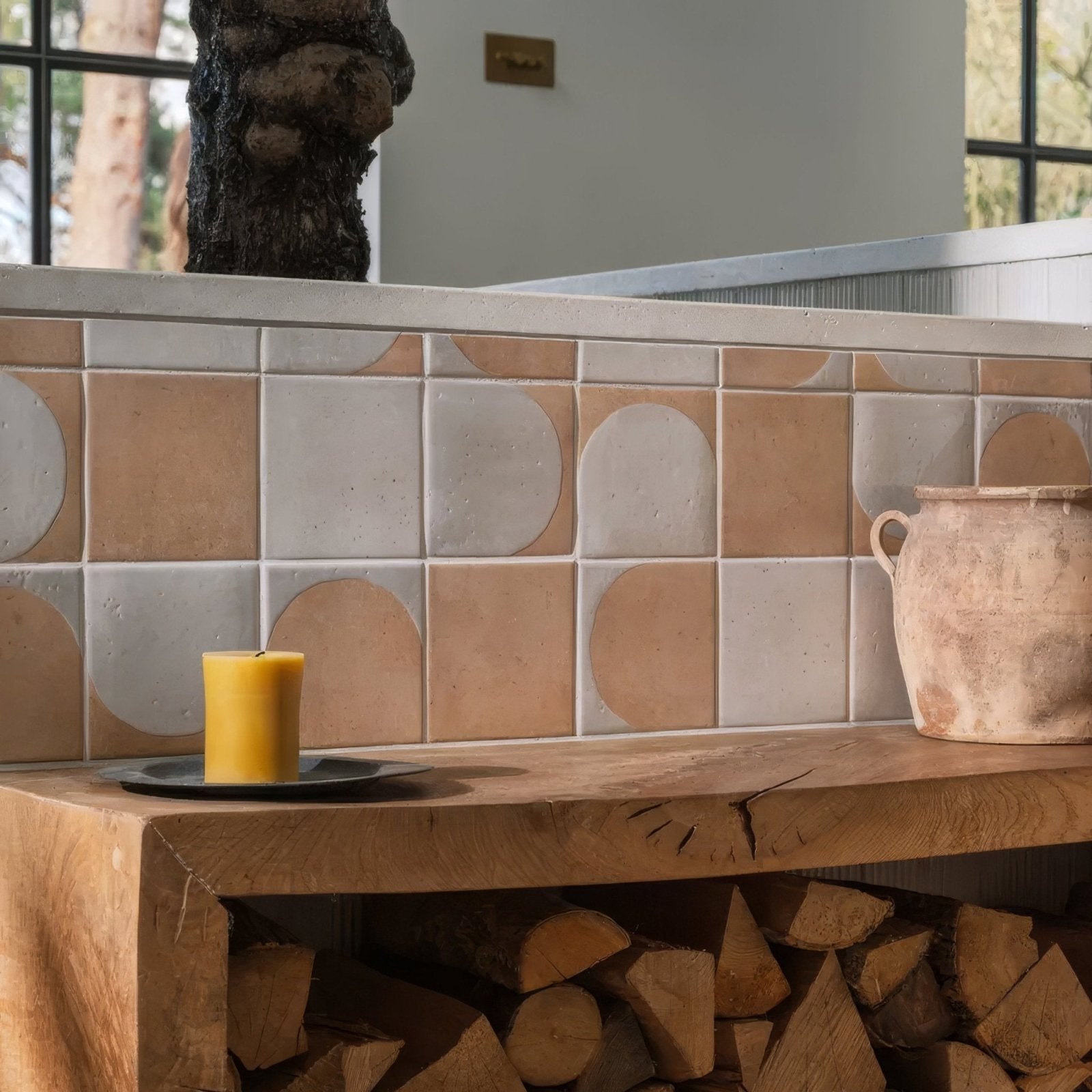 A rustic terracotta ceramic jar with two handles and an earthy finish in the Menara White Arches Porcelain collection