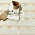 A rustic wooden pitcher with handle and spout in natural wood finish featured with menara white arches porcelain design