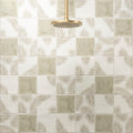 Gold-toned circular showerhead with multiple spray nozzles for Mere Field Tile bathroom installation