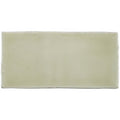Cream-colored ceramic mere half tile wall tile with smooth glossy finish and rectangular shape for wall use