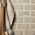 Beige rectangular mere half tile wall tiles with a matte slightly textured finish in a classic brick pattern