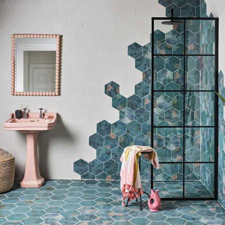 Mermaid's Garden Porcelain teal hexagonal botanical porcelain tile with a pink pedestal sink and beaded mirror