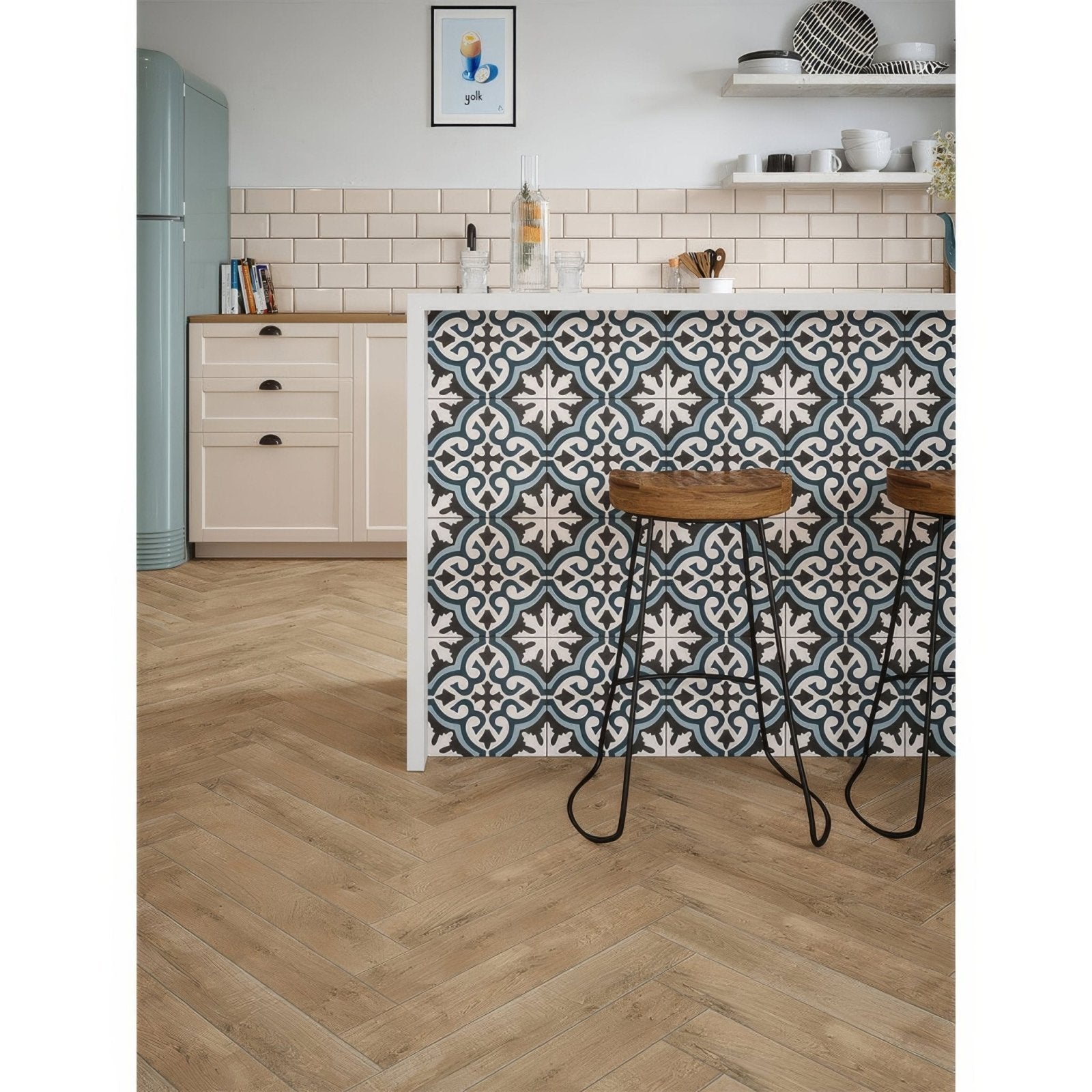 The metro bone ceramic gloss kitchen island features a patterned tile backsplash with teal white and dark gray geometric designs