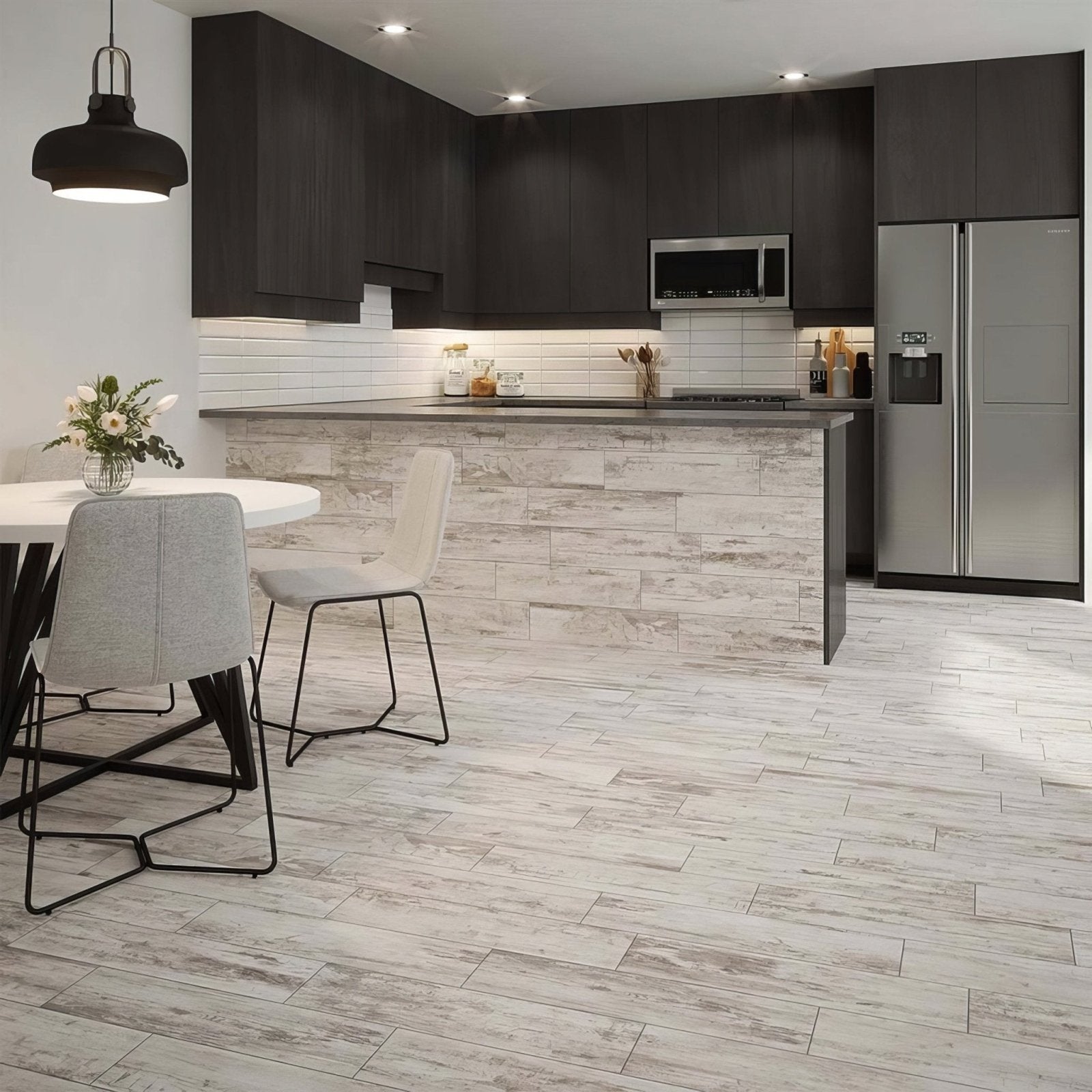 Modern kitchen featuring metro white ceramic brick tile with dark cabinets stainless steel appliances and gray flooring