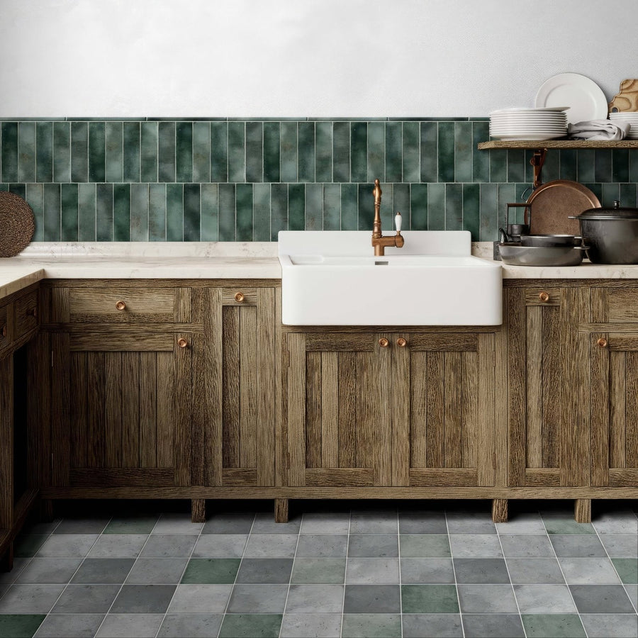 White farmhouse sink with brass faucet set into rustic wooden cabinets in the metropolitan barcelona collection