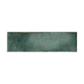 A rectangular matte-finished teal ceramic tile with subtle texture and uneven edges from metropolitan barcelona collection