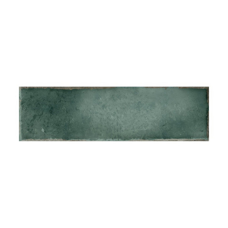A rectangular matte-finished teal ceramic tile with subtle texture and uneven edges from metropolitan barcelona collection