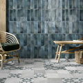 Blue-gray rectangular ceramic tiles with a matte textured finish forming a metropolitan paris wall surface