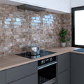 A sleek stainless steel Metropolitan Rome pot with a reflective lid sits on a black induction cooktop