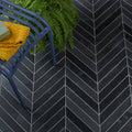 Black herringbone patterned metropolitan slate chevron riven finish tiles with white grout lines