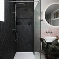 Modern black metropolitan slate chevron riven finish herringbone tiled shower wall with built-in shelves and chrome rainhead