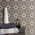 Gray and white geometric patterned bathroom tiles with a subtle distressed finish from mezzo molto collection
