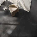 Milos Black 80 x 80cm dark grey marble-effect tiles with a beige armchair