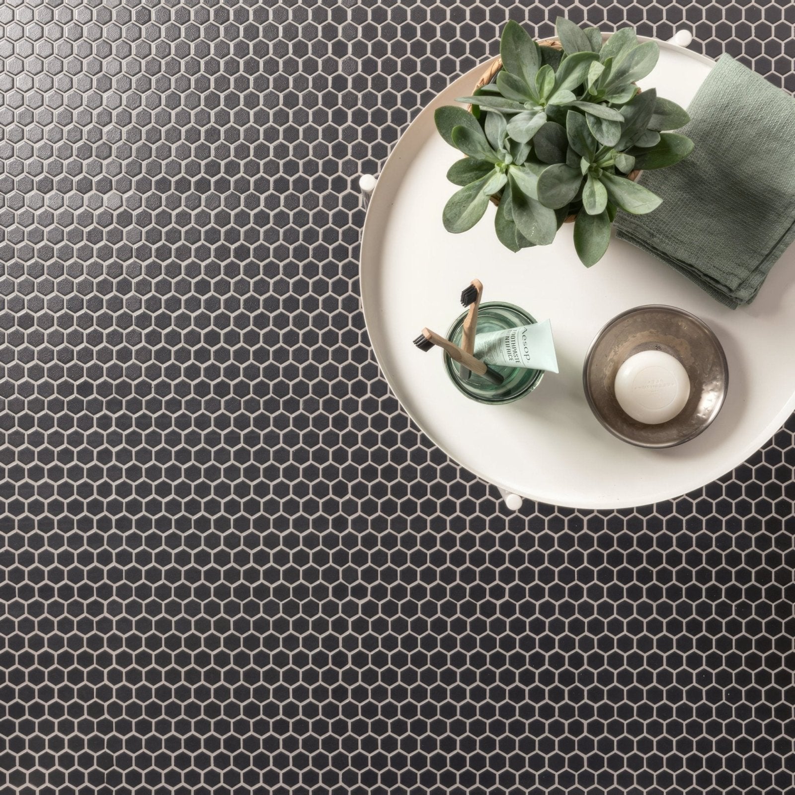 Mini black hexagon slip resistant tile featuring black hexagonal mosaic pieces with a subtle metallic sheen