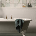 Mini White Penny Round white penny round mosaic with a white clawfoot bathtub and gold taps