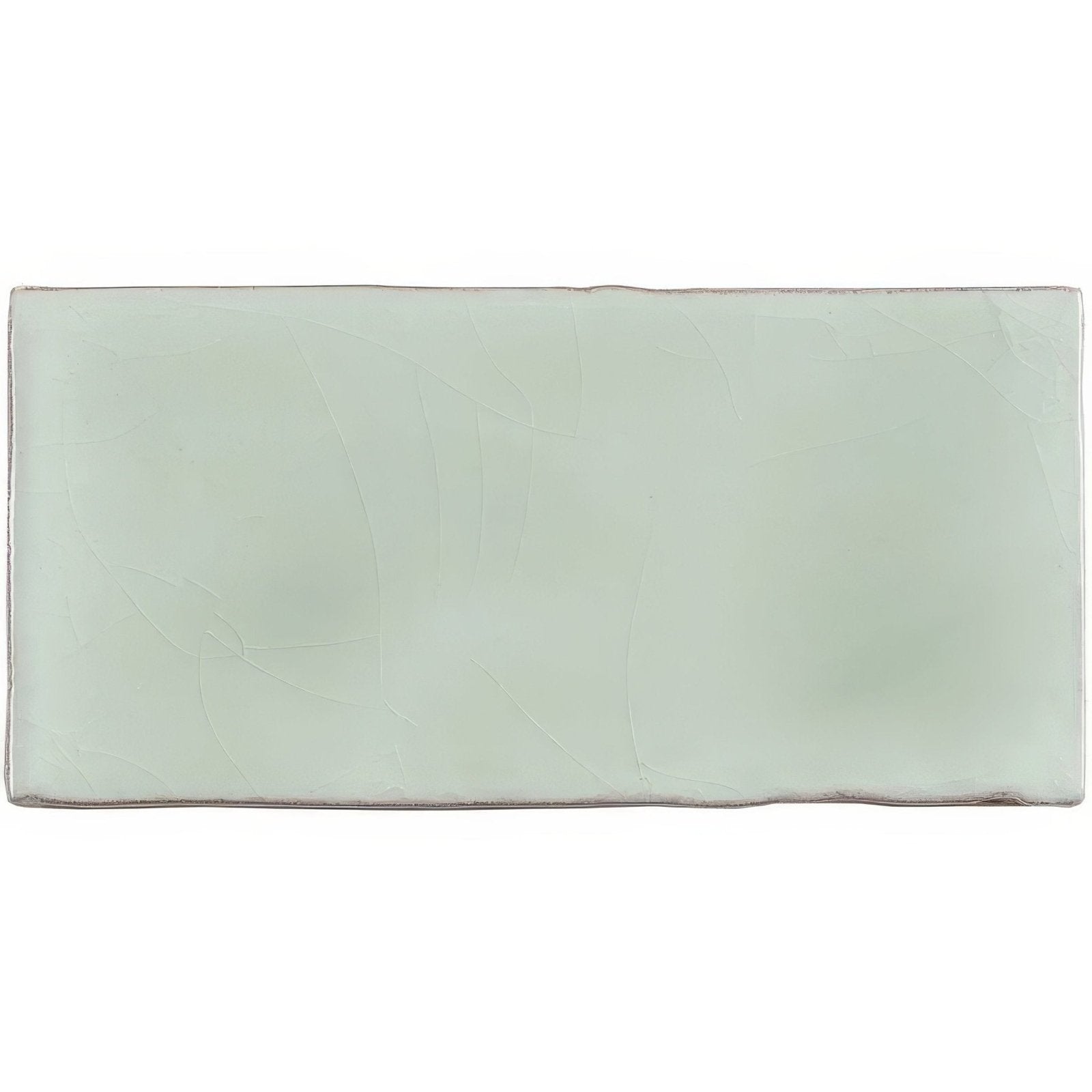 A rectangular matte finished ceramic wall tile in soft mint green with subtle surface texture for half tile use