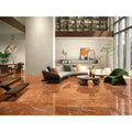 The floor covered in polished mistral 1863 rojo warm-toned orange marble tiles with subtle white veining