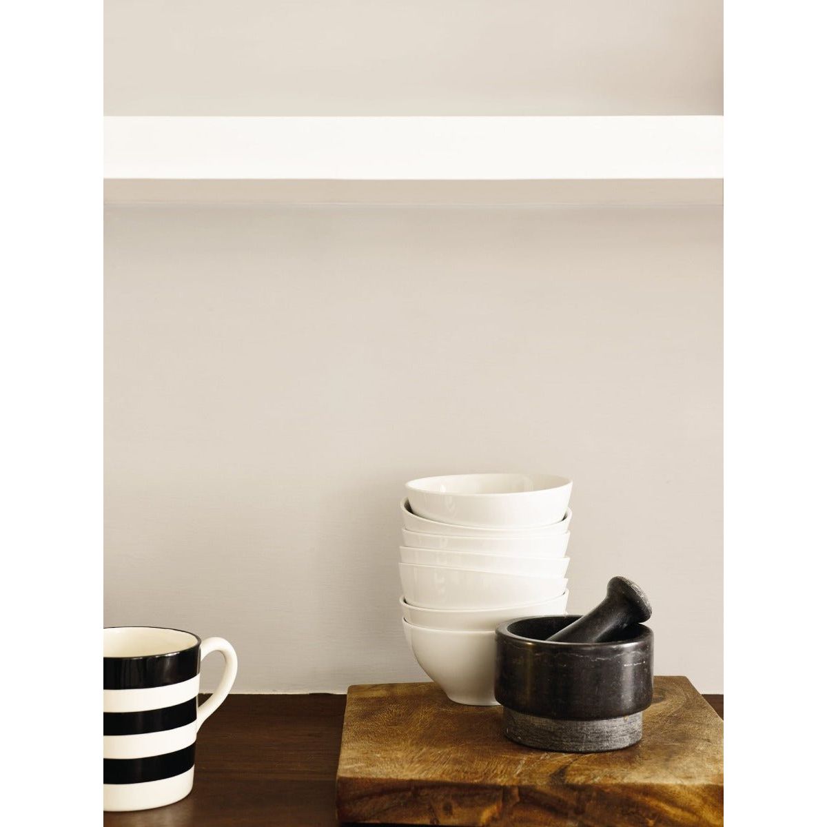 Stack of modernist white ceramic bowls showcasing smooth finish and minimalist design for versatile use