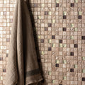 Mogao Glass and Stone Mosaic silver and black glass and stone mosaic with a taupe waffle-weave towel