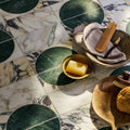 Monet Luna Calacatta green and white marble mosaic with a soap bar in a gold bowl