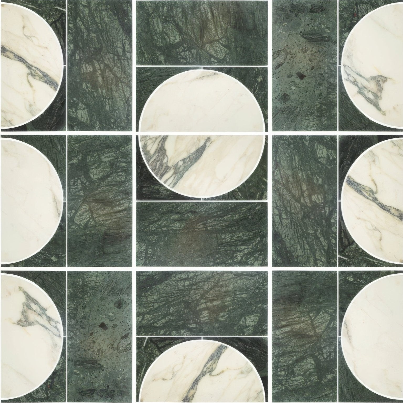 Circular white marble tiles with dark veining paired with textured deep green monet luna verde stone panels