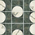 Circular white marble tiles with dark veining paired with textured deep green monet luna verde stone panels