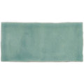 A rectangular half tile moselle ceramic tile with a soft teal glaze and subtle crackle texture