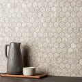 Murano Grey Glass Hexagon Mosaic grey hexagonal glass mosaic with a grey ceramic pitcher on a tray