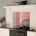 Black electric stove with glossy finish and silver oven handle featured in musk field tile product setting
