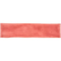 A rectangular coral-colored silicone headband with a smooth textured surface from musk large brick tile collection