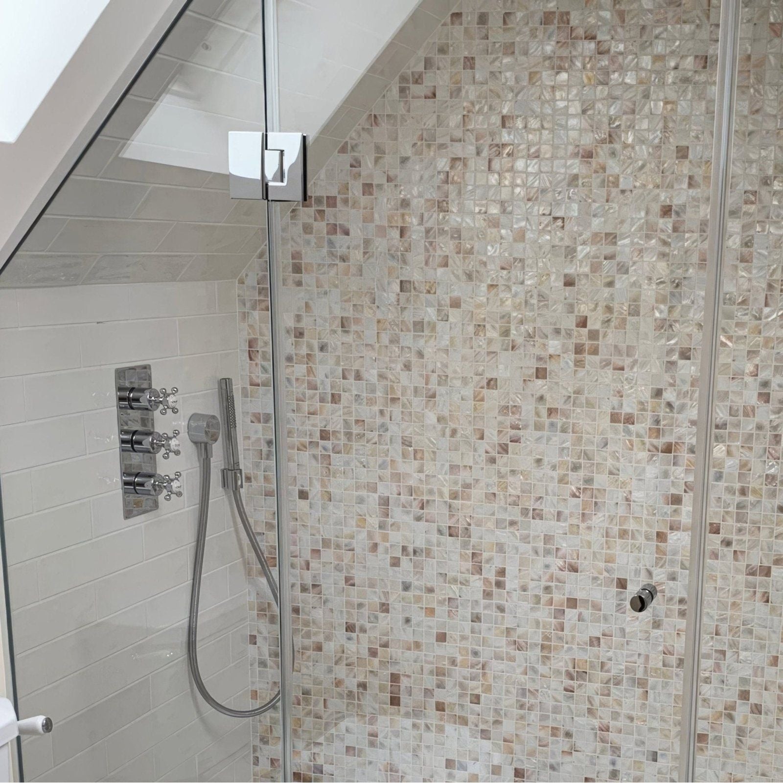 Natural 25mm square shower wall mosaic featuring iridescent mother-of-pearl tiles in soft beige and cream tones