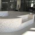 Natural 25mm Square iridescent mother-of-pearl mosaic on a curved multi-tiered hot tub