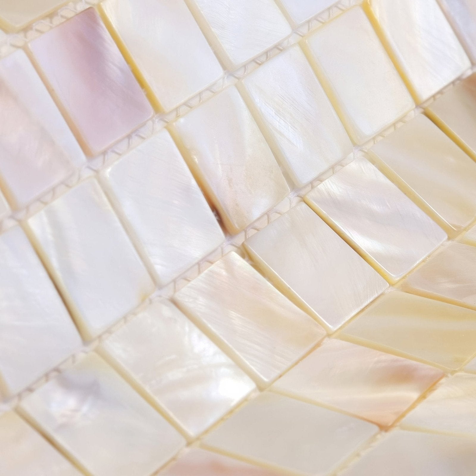 Iridescent mother-of-pearl mosaic tiles natural 25mm square in a subtle pink cream and white gradient color