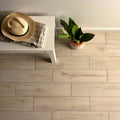 Naturalia Grey light grey wood-effect porcelain tiles with a straw fedora