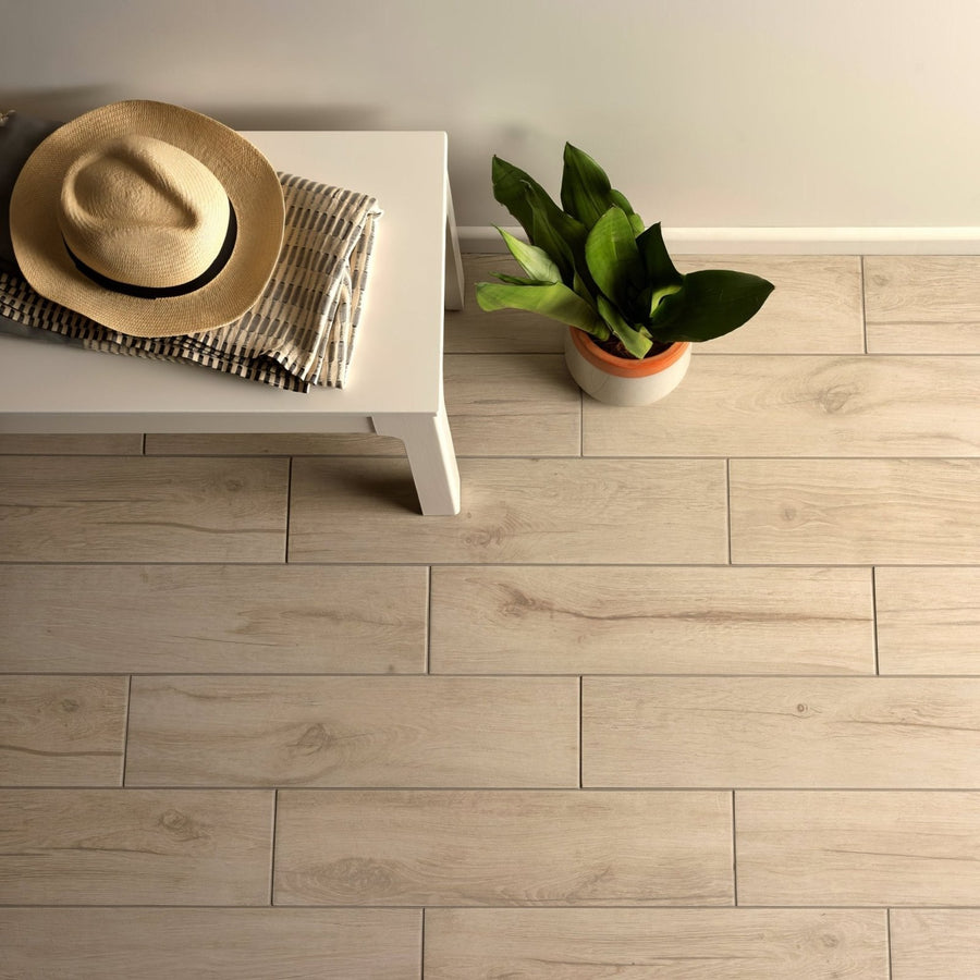 Naturalia Grey light grey wood-effect porcelain tiles with a straw fedora