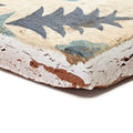Antique ceramic tile neisha crosland atlas pine flower indigo with weathered cream surface and faded blue gray leaf patterns