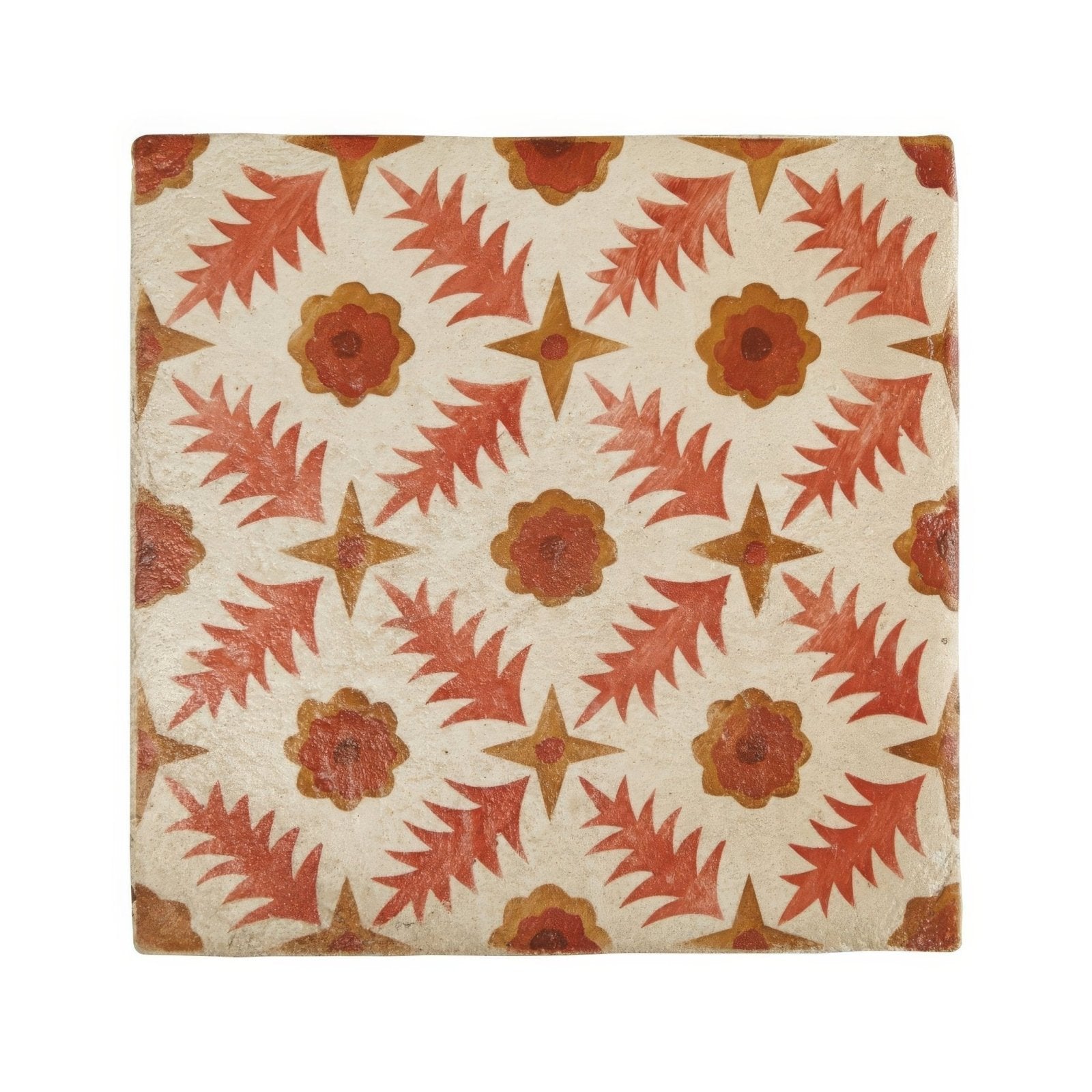 A square ceramic tile with a textured off-white surface featuring orange and rust floral starburst motifs from Neisha Crosland Atlas Pine Flower Paprika