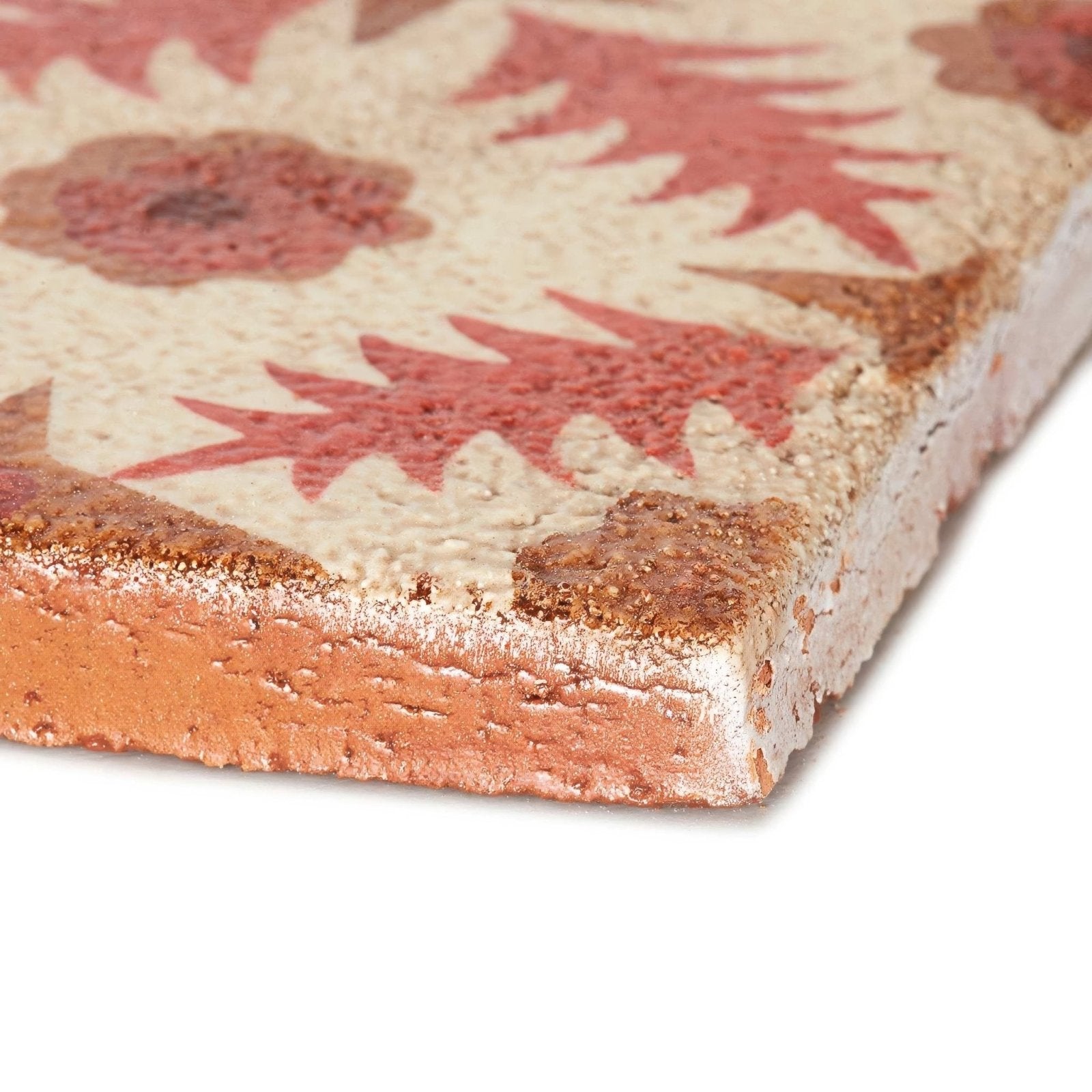 Rustic terracotta tile with textured weathered surface and hand-painted red floral patterns by neisha crosland atlas pine flower paprika