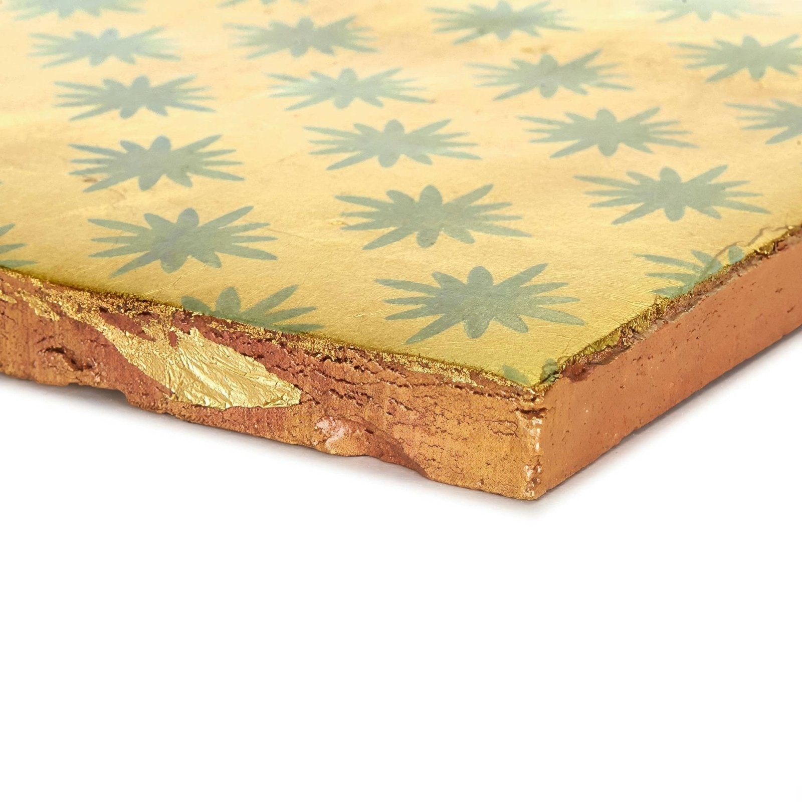 A square ceramic tile by neisha crosland atlas star anise sahara with golden-yellow surface and green starburst pattern