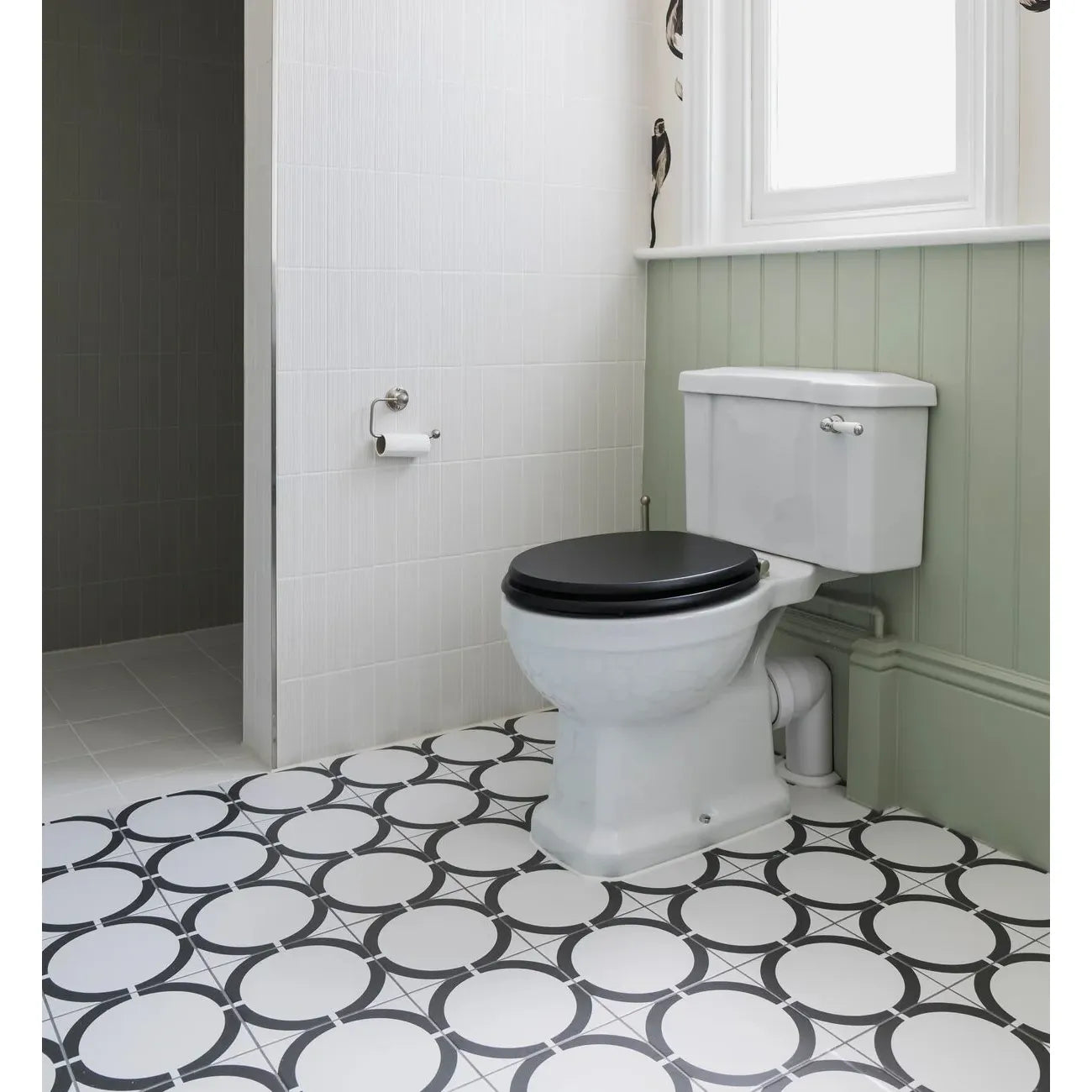 White ceramic toilet with black seat and lid from neisha crosland tulia hula hoop black collection