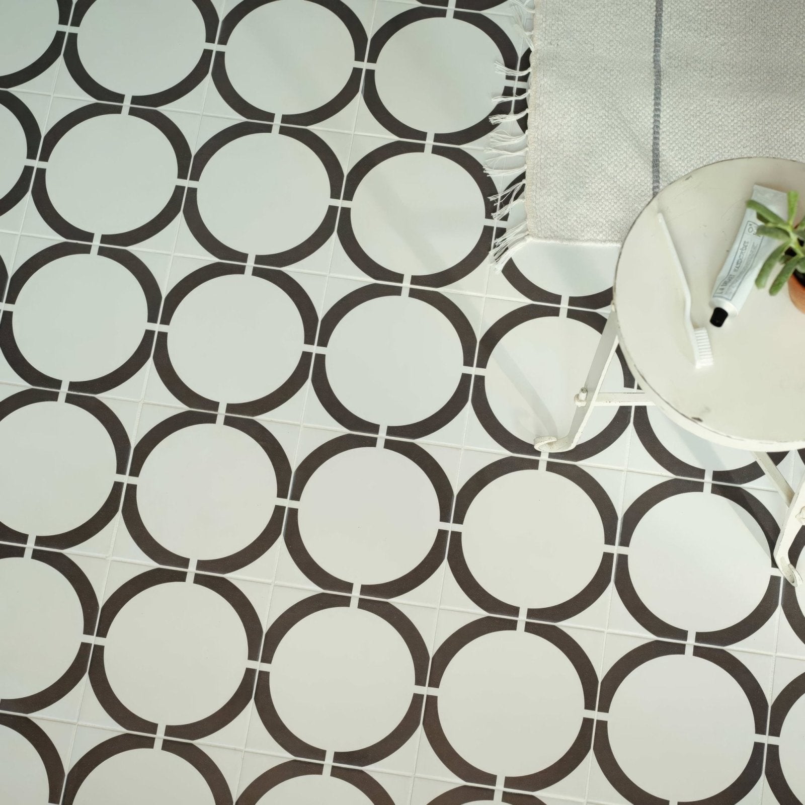 White and black circular patterned floor tiles from neisha crosland tulia hula hoop black collection